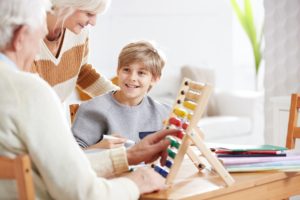 Boy studying math with grandparents
